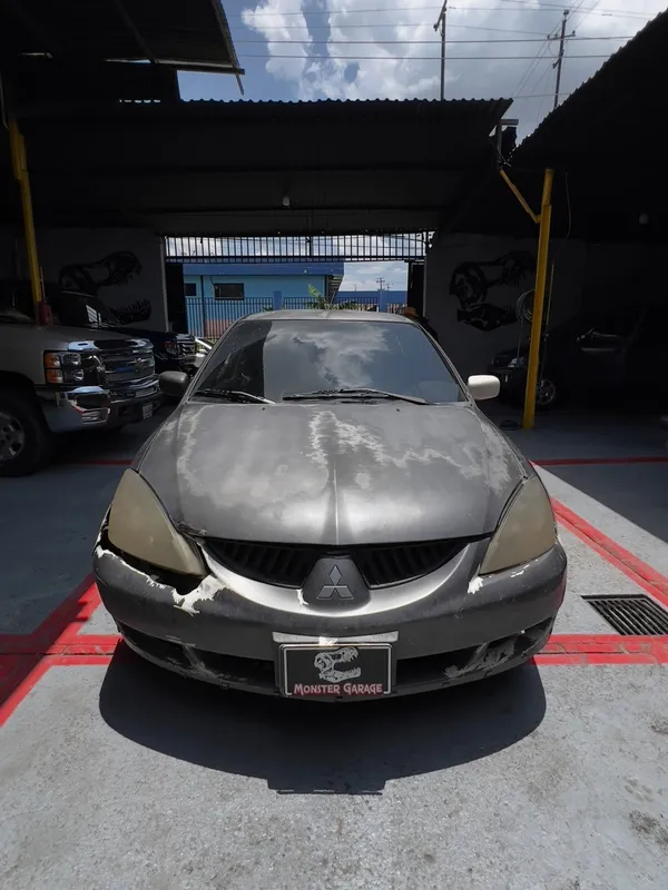 Mitsubishi Lancer gris: frente antes, en Monster Garage Vzla
