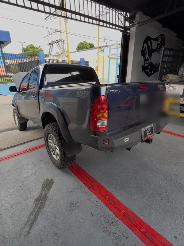 Toyota Hilux gris a negro: trasera antes, en Monster Garage Vzla
